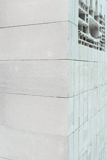 A corner of a wall built from light grey aerated concrete blocks